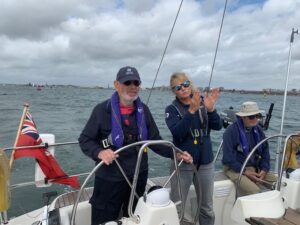 Day Sailor Mile at the wheel with Pip Hare explaining details to him