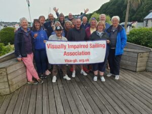 All crew standing behind the Visa-gb banner at the end of the milford haven trip