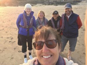 Yacht crew on the beach, in front is Adele taking a selfie with Visually impaired sailors, Julia, Anita and Vjay behind along with David Muldoon.  